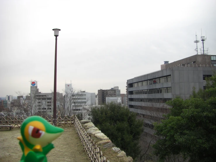 a tall building and a big city with a bird statue