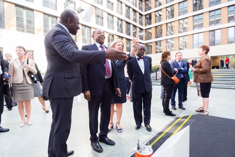 men and women are standing on a sidewalk