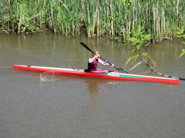 the woman is rowing her boat in the water