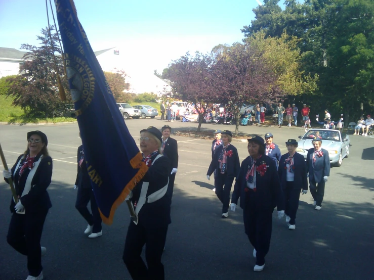 some people are carrying flags and marching down a street