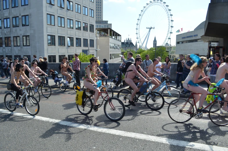 the peope are biking in unison through the city