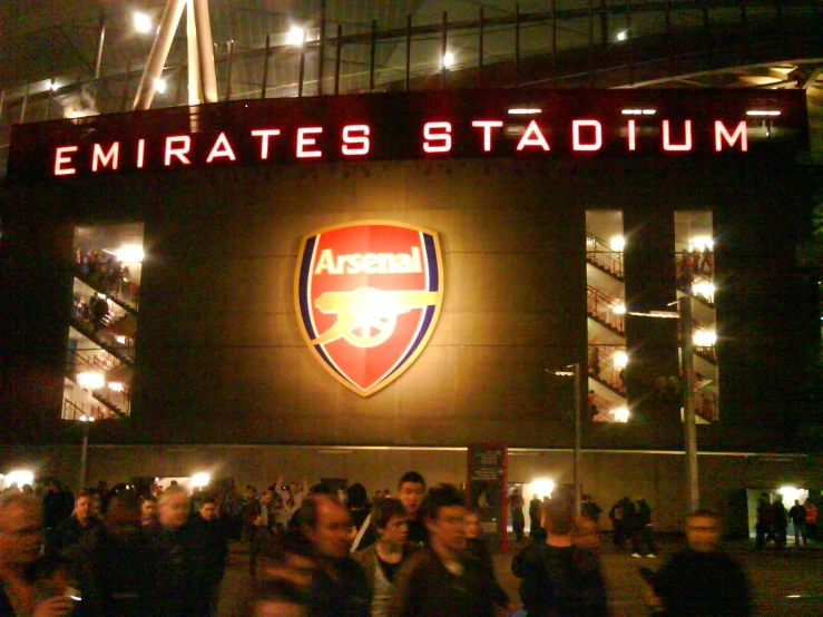 fans outside emirates stadium at night