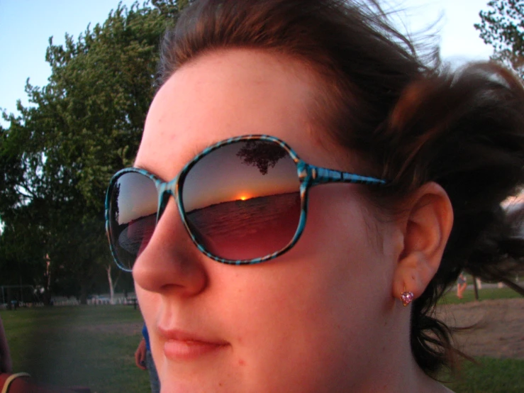 a woman wearing sunglasses is staring over her shoulder