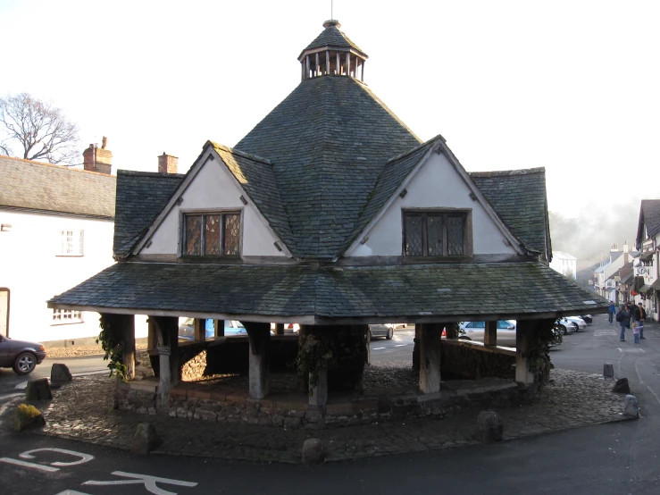 a small round building sitting on the side of a road