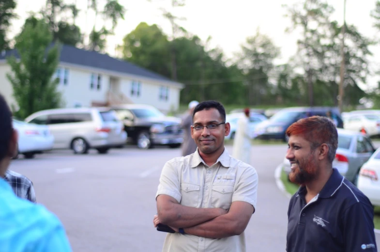 two men are standing in the middle of a parking lot