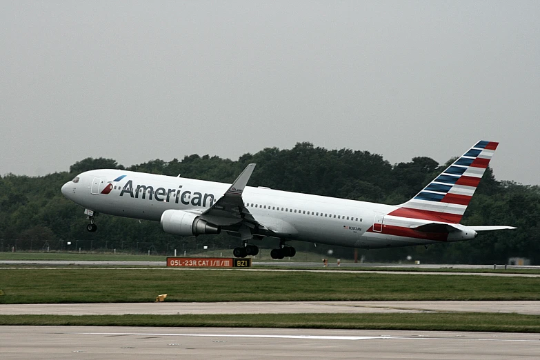 the american airlines is about to take off from an airport runway