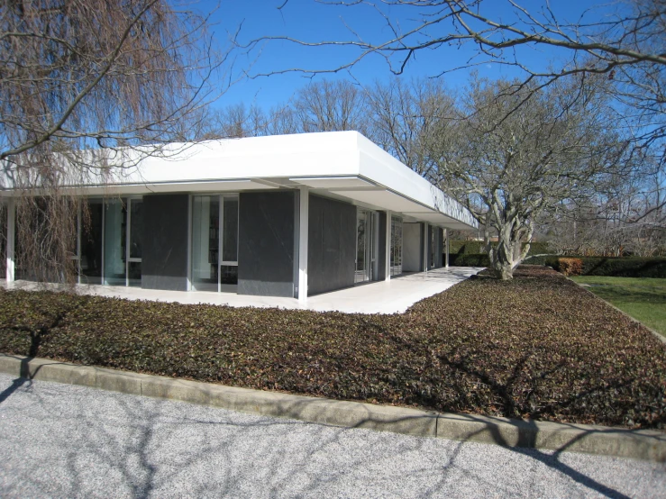 a couple of building are shown near some bushes