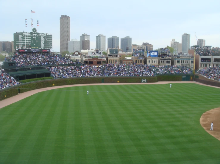 a stadium filled with lots of people playing baseball