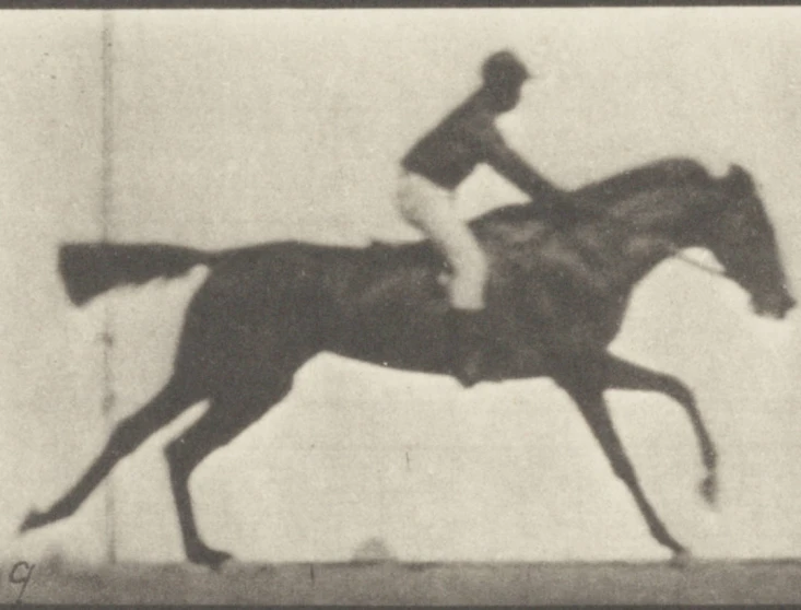 an old black and white po of a man riding a horse