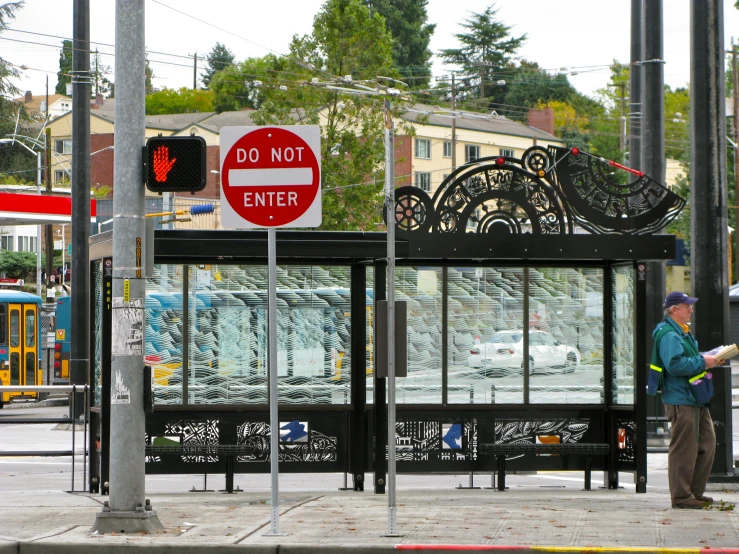 a bus stop with a man by it