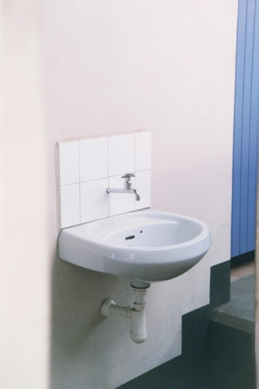 a bathroom sink on a wall in a small room