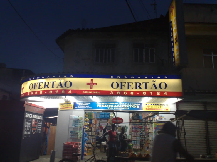 a gas station sign on the side of a building at night