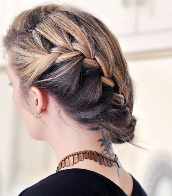 woman with id hairs styled in low bun