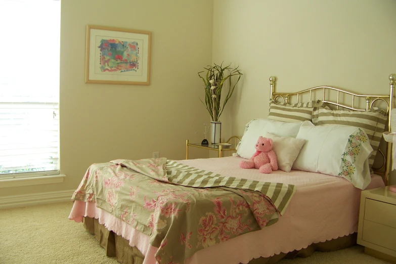a bedroom with an unmade bed, dresser and flowers