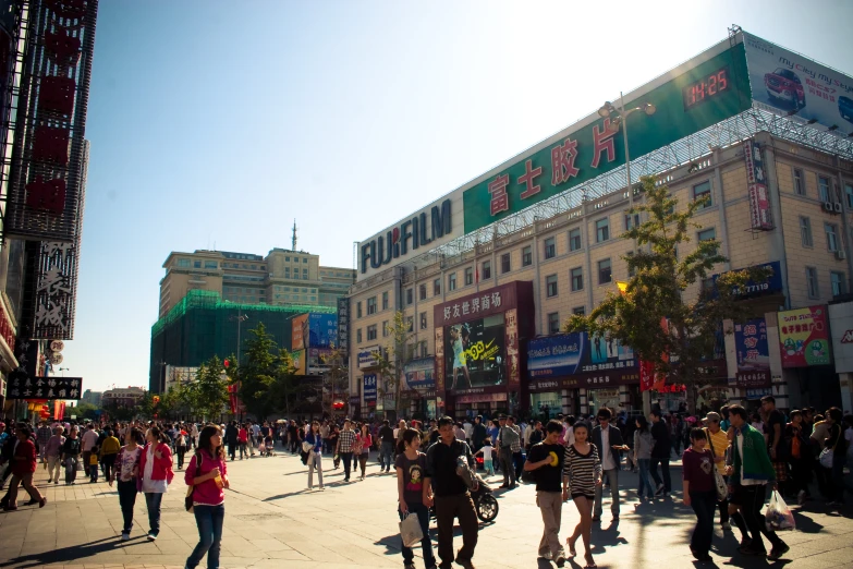 many people walking around on a city street