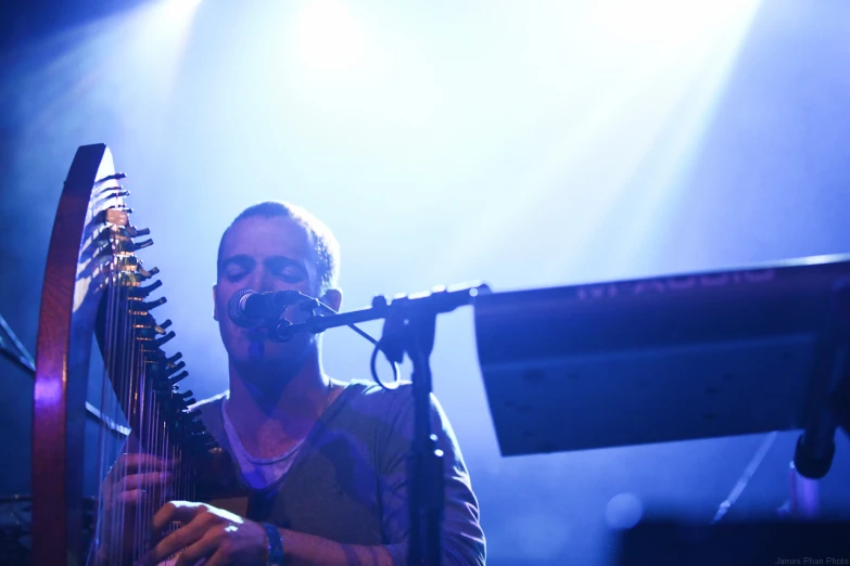 a man holding a large instrument while smiling