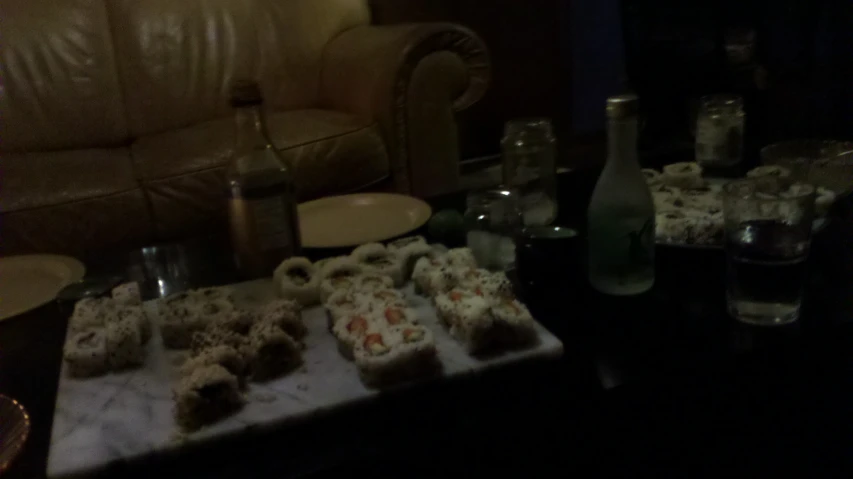 several pastries on the table in front of a bottle
