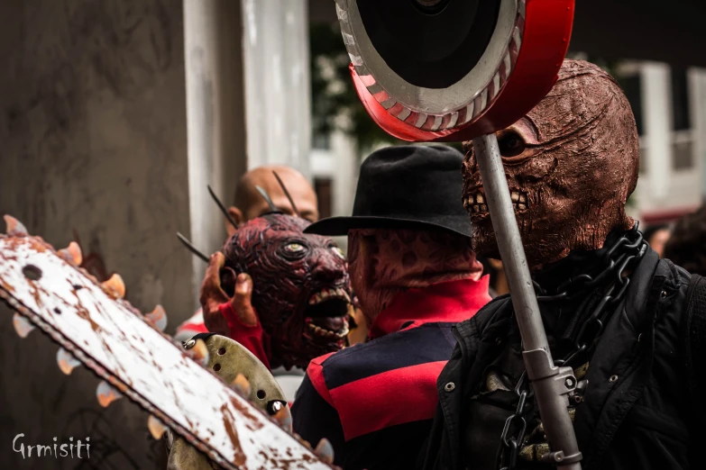 several people with face masks holding metal items