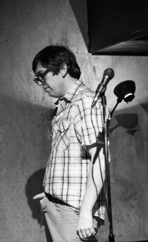 a young man standing in front of a microphone