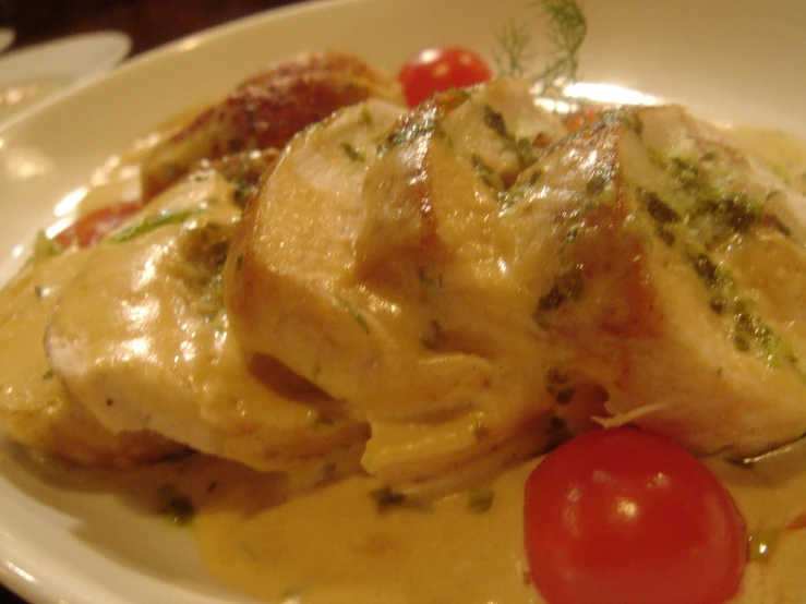 close up of chicken with tomato sauce on the plate