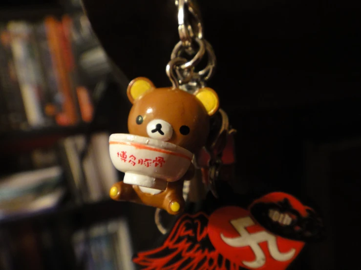 a little brown bear with some keys hanging from it