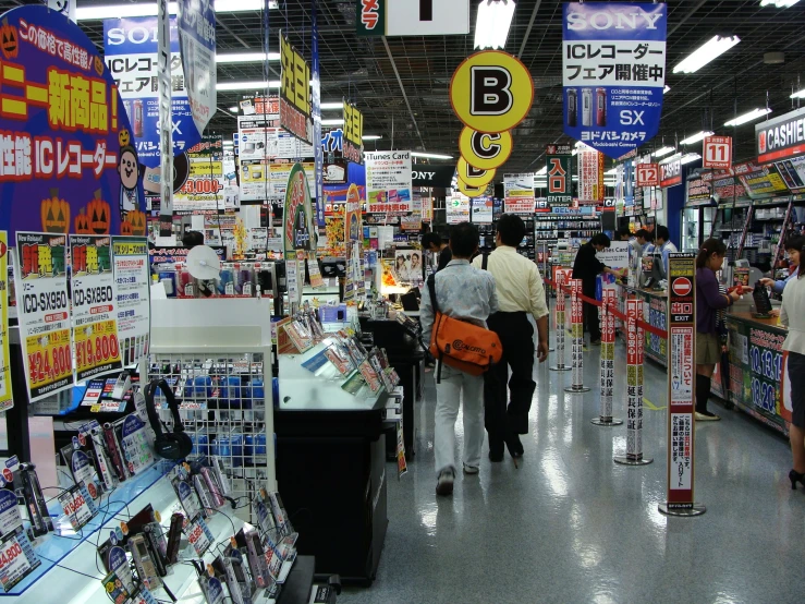 people shop in a store with lots of signs