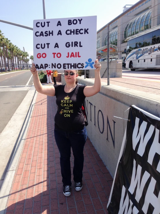 the young woman is holding up a sign in protest