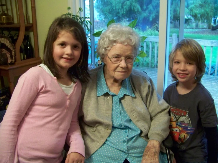 two children and an older woman sitting next to each other