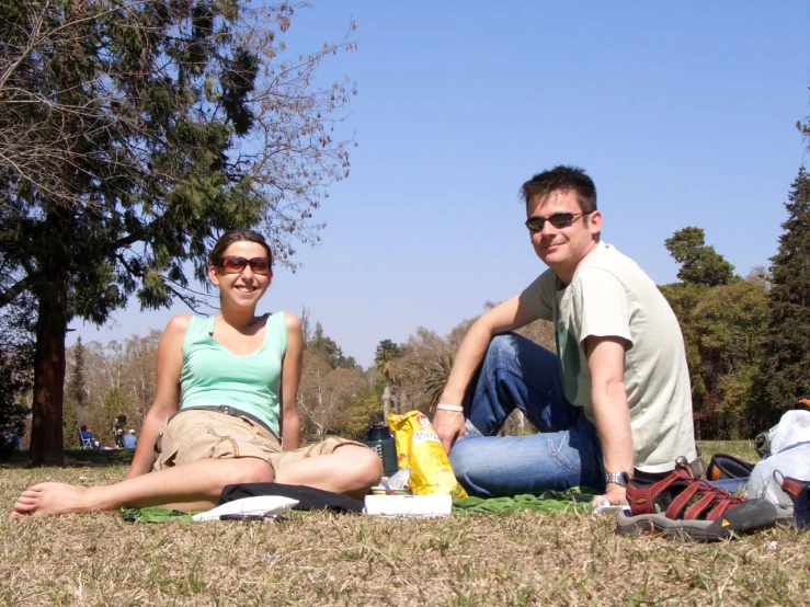 a couple of people sitting on a field together