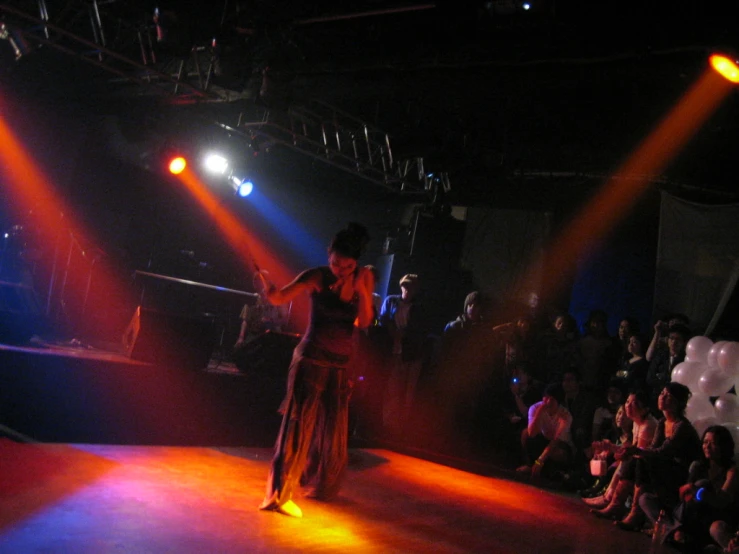 a woman walking down the runway at a fashion show