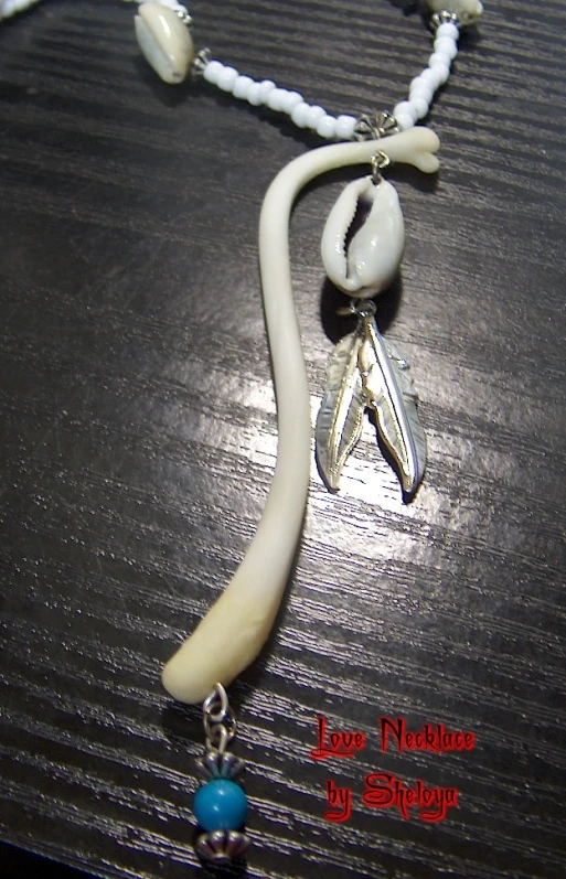 a white necklace with blue beads on a table