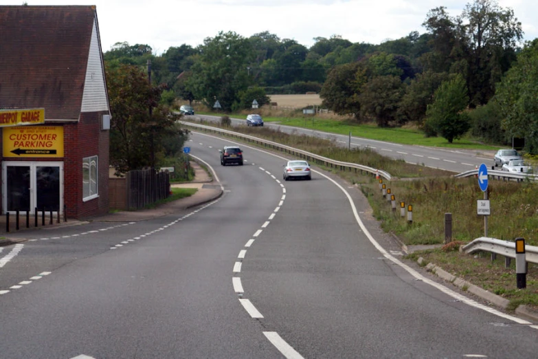 two vehicles are stopped on the street corner