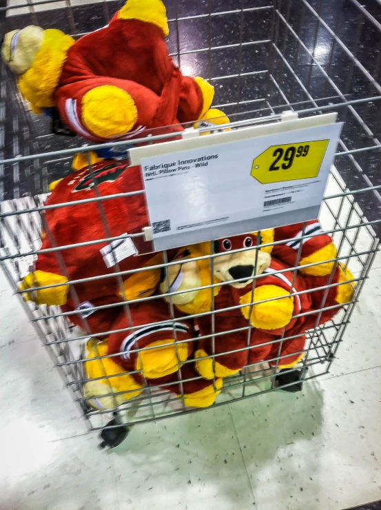 a wire basket with stuffed animals in it