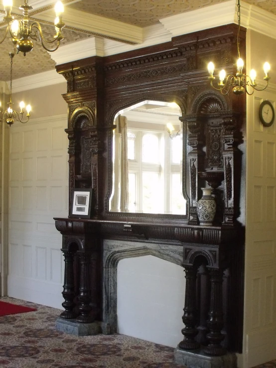 an old mirror is shown behind a fireplace