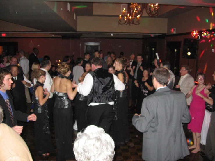 people are dressed up and dancing at a party