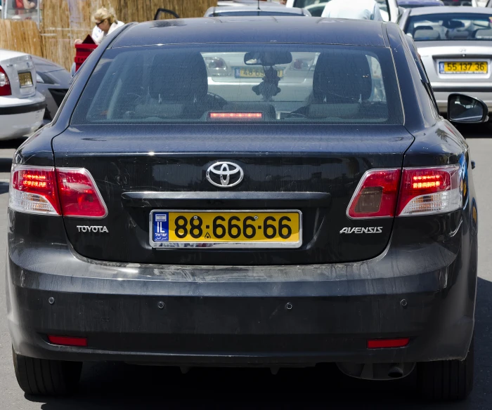 a very large grey car parked in a lot