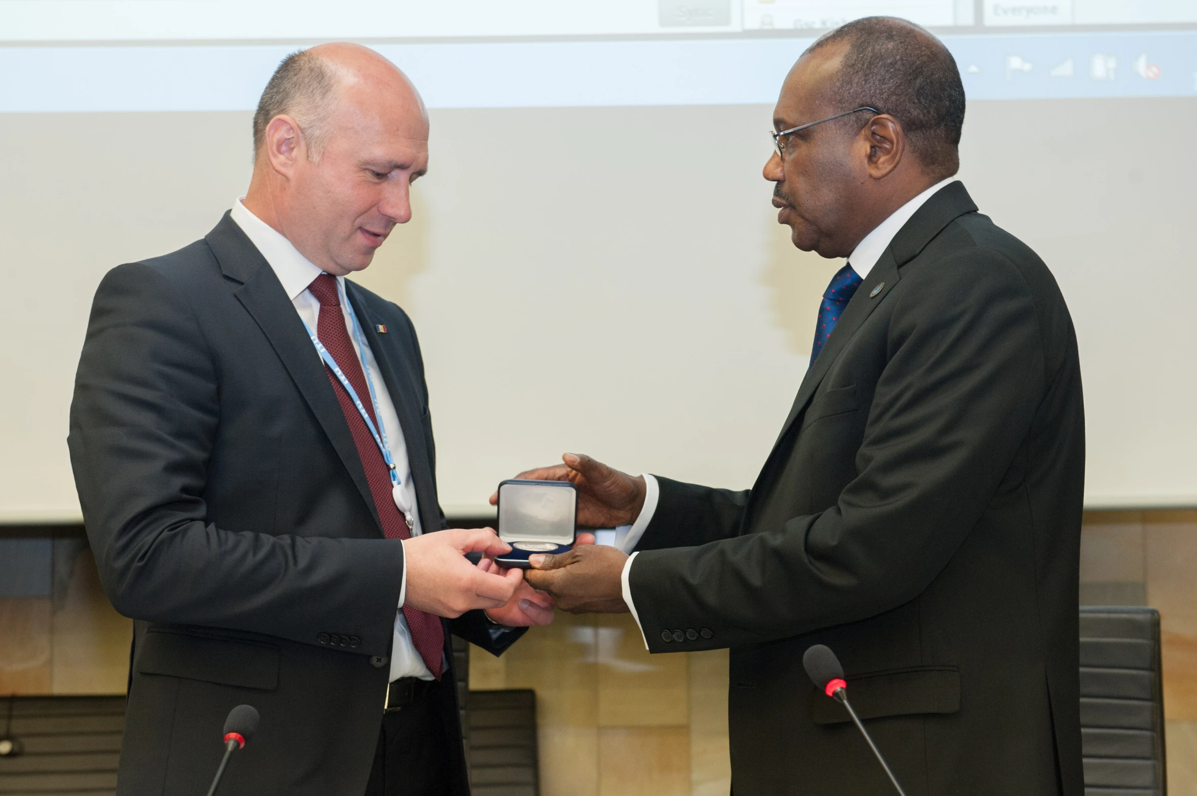 two men exchanging soing at the conference