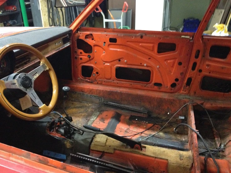 old red car interior with wooden steering wheel