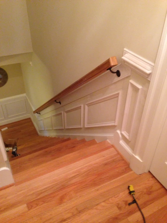 an unfurnished entryway and a wall with wood and marble paneling