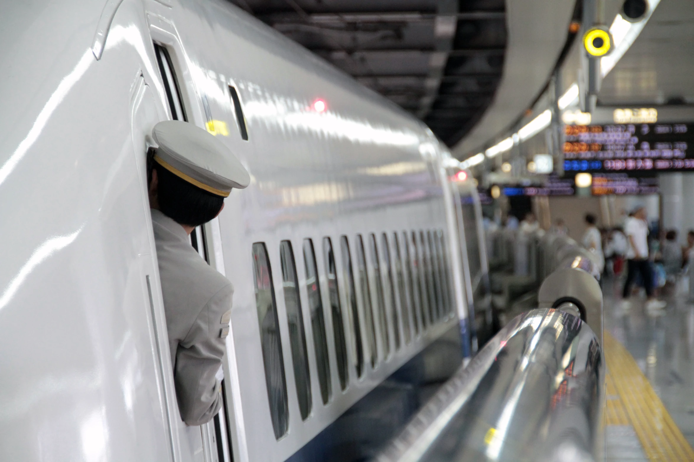 a man sticking his head out of a subway car