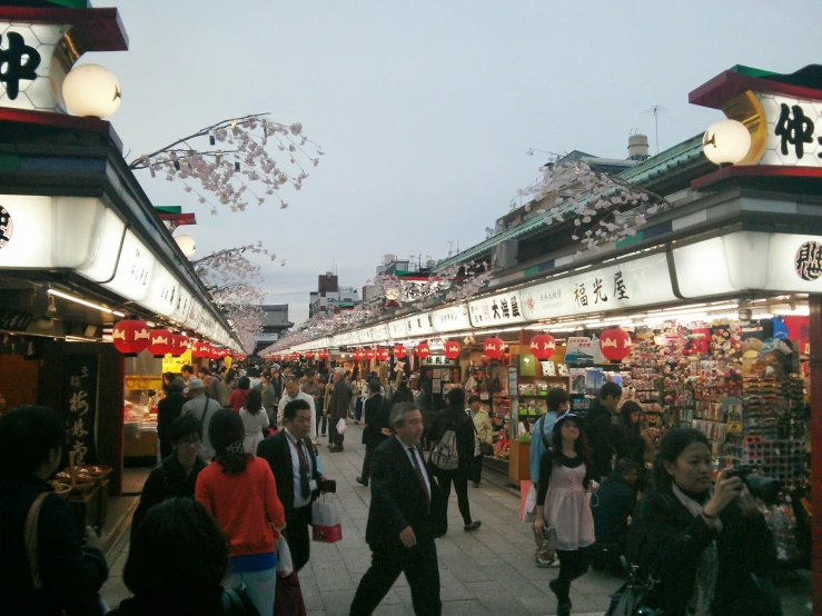 a crowded city street in china at dusk