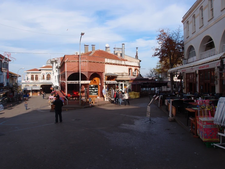 a wide open street with small shops and shops on each side