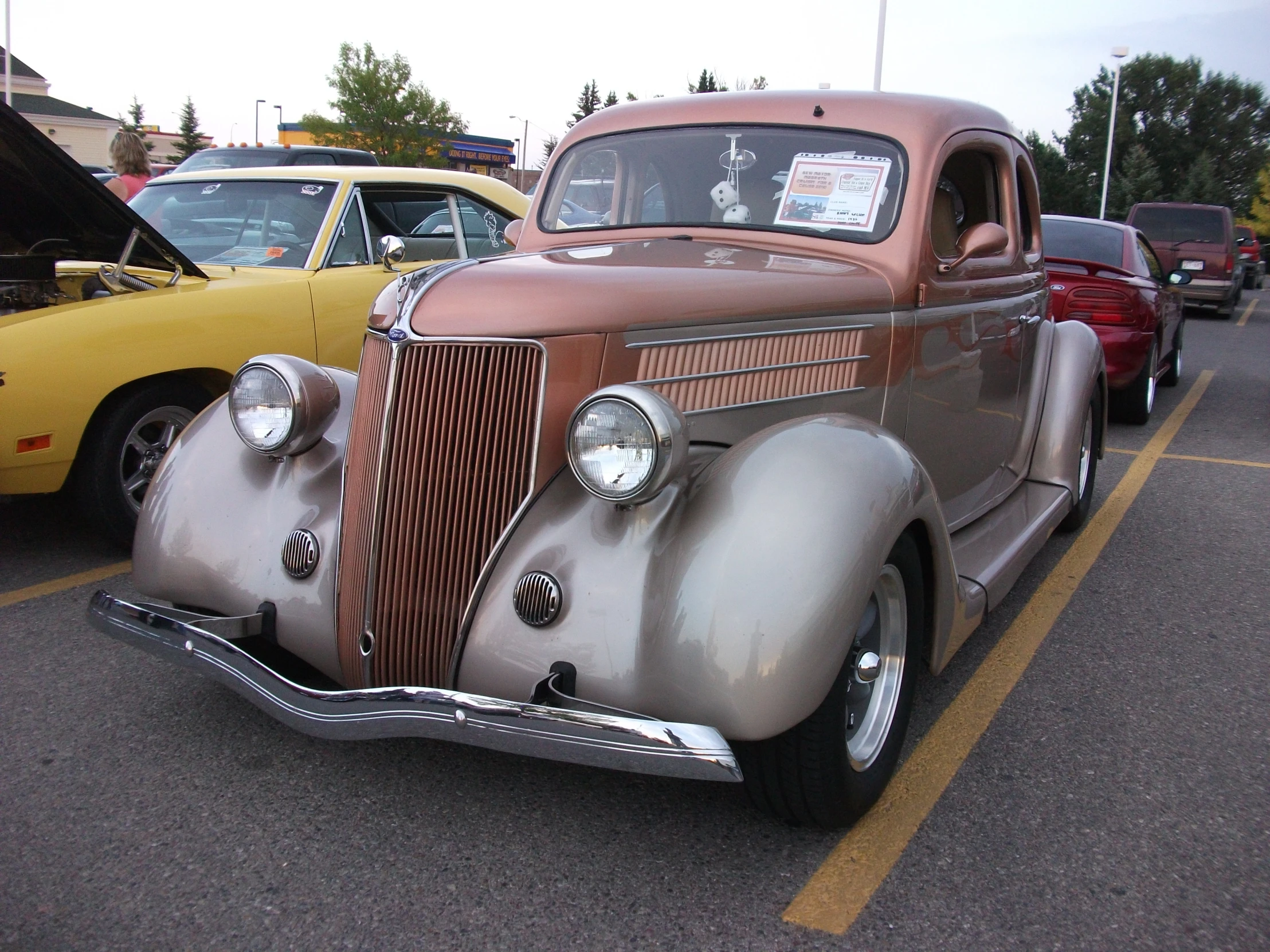 an old car that is parked in the parking lot