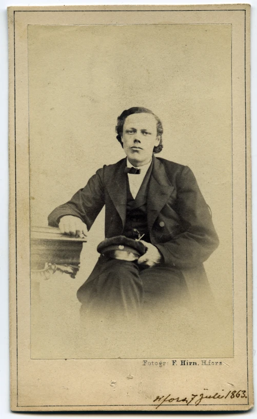 an old - fashioned black and white portrait of a man wearing a suit