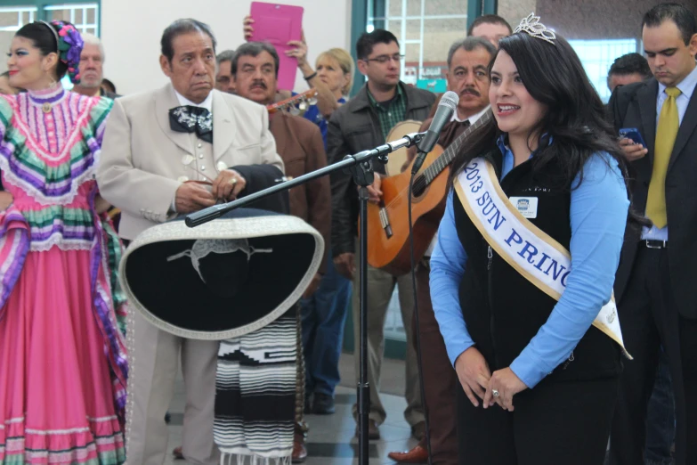 a young woman is speaking at an event