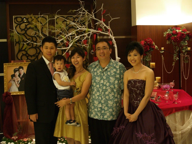 a family poses for a pograph in a formal dress