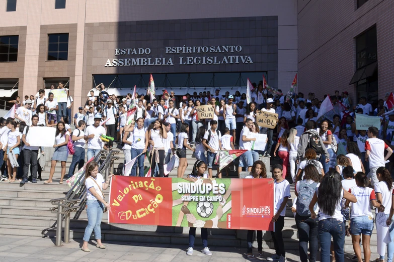 people in front of a building with signs and people on steps