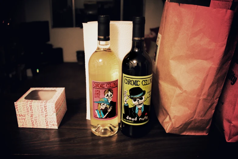 some wine bottles sitting on a table with paper bags