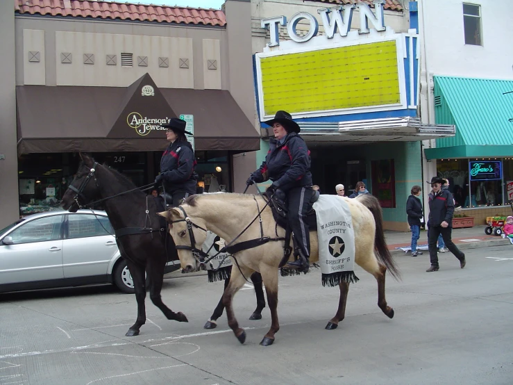 two mounted police officers on horses on the street