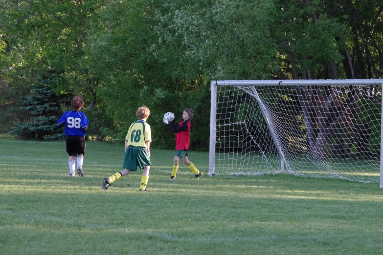 a group of boys playing a game of soccer